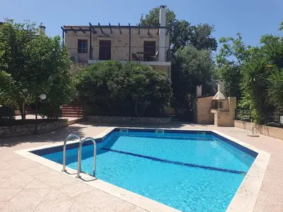 a swimming pool in front of a house at Villa Eudokia Terrace Views Pool in Douliana