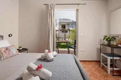 a bedroom with a bed with two stuffed animals on it at Sellianos Apartment In Kalyves -BY APOKORONAS VILLAS in Kalyves
