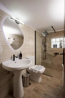 a bathroom with a sink and a shower and a toilet at Sellianos Apartment In Kalyves -BY APOKORONAS VILLAS in Kalyves