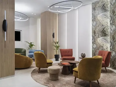a lobby with chairs and a table and a couch at Hilton Garden Inn Chania City in Chania Town