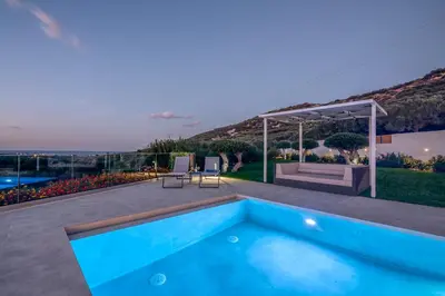 a villa with a swimming pool and a patio at Casa Elea in Kissamos