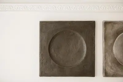 a pair of paintings of plates on a white wall at Eva's Apartment in Chania Town