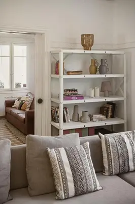 a living room with a couch and a book shelf at Eva's Apartment in Chania Town