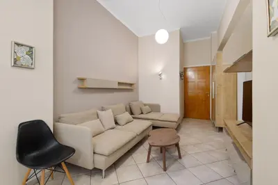 a living room with a couch and a chair at Architects Oasis in Chania Town