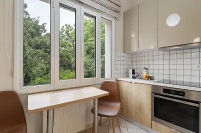 a kitchen with a counter and two windows at Architects Oasis in Chania Town