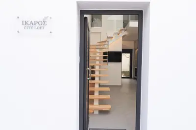 a staircase in a house with a glass door at Ikaros City Loft in Chania Town