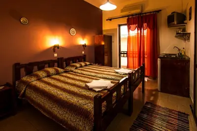 a bedroom with a large bed in a room at Savas Rooms in Palaiochóra