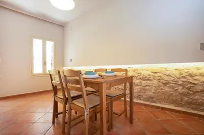 a dining room with a wooden table and chairs at Artemis House in Chania Town