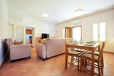 a living room with a dining room table and chairs at Artemis House in Chania Town