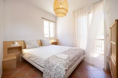 a bedroom with a bed in a room with windows at Artemis House in Chania Town