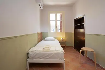 a hospital room with a bed and a window at Artemis House in Chania Town
