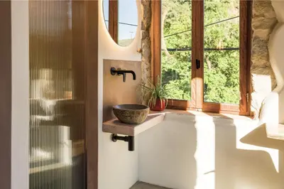 a bathroom with a sink and a window at Mozaik House