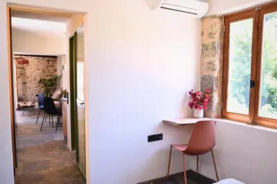 a hallway of a house with chairs and a window at Mozaik House