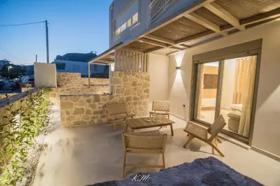 a patio with chairs and a table on a building at Kalmar mindful living in Palaiochóra
