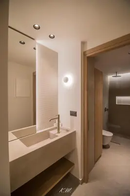 a bathroom with a large sink and a toilet at Kalmar mindful living in Palaiochóra