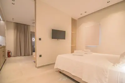 a bedroom with a bed and a tv on the wall at Kalmar mindful living in Palaiochóra