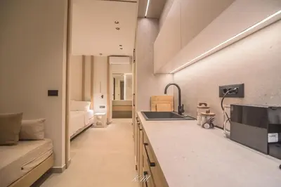 a kitchen with a sink and a couch in a room at Kalmar mindful living in Palaiochóra