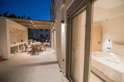 a room with a balcony with a table and chairs at Kalmar mindful living in Palaiochóra