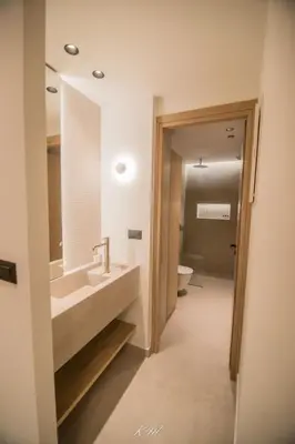 a bathroom with a sink and a toilet at Kalmar mindful living in Palaiochóra