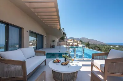 a villa with a view of the pool and the patio of a house at Villa Tierra in Kissamos