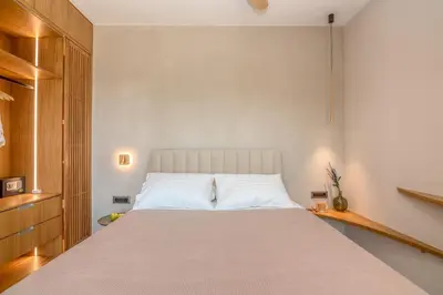 a bedroom with a large bed with white pillows at Villa Tierra in Kissamos