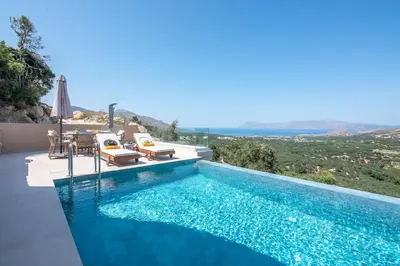 a swimming pool with a view of the ocean from a villa at Villa Tierra in Kissamos
