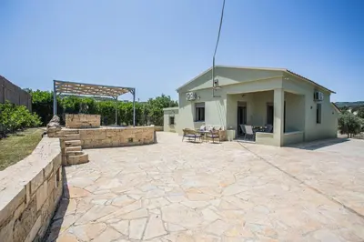 a patio in front of a house with a building at Be Crete - Villa Vayanna in Sirílion