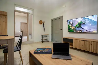 a living room with a laptop on a wooden table at Be Crete - Villa Vayanna in Sirílion