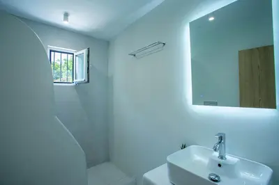 a white bathroom with a sink and a mirror at Be Crete - Villa Vayanna in Sirílion