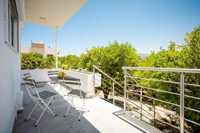 a patio with a table and chairs on a balcony at Mantarini House in Chania Town