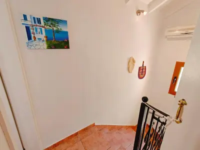 a staircase with a painting on the wall at Kalives pearl suite in Kalyves