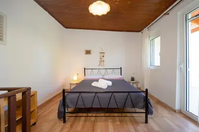 a bedroom with a bed with two pillows on it at Galatas Maisonette in Galatás