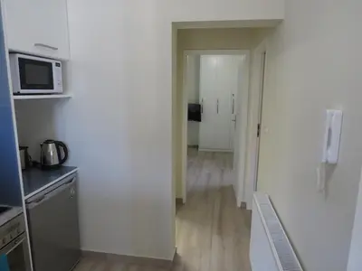 an empty room with a kitchen and a microwave at Cosy apartment in Koum Kapi Beach in Chania Town