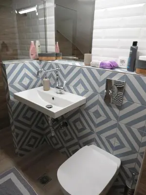 a bathroom with a white sink and a toilet at Cosy apartment in Koum Kapi Beach in Chania Town