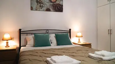 a bedroom with a bed with two towels on it at IKARUS apartment with courtyard & pool in Chania in Stérnai