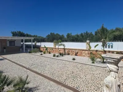 a garden with a stone pathway and a fence at Villa Dadis in Chania
