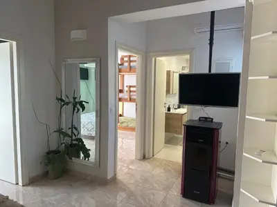 a living room with a flat screen tv and a mirror at Vila Alexandros in Souda