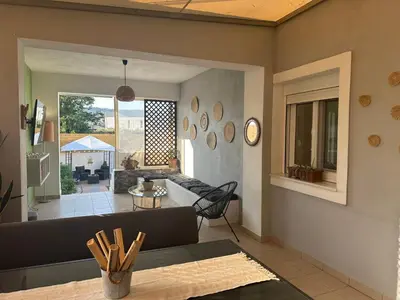 a living room with a couch and a table at Vila Alexandros in Souda