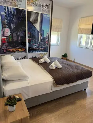 a bedroom with a large bed with two towels on it at Serenity apartment sea view in Souda