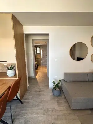 a living room with a couch and a mirror at Gialos Villas Paleochora in Palaiochóra
