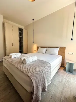 a bedroom with a large bed with a blanket on it at Gialos Villas Paleochora in Palaiochóra
