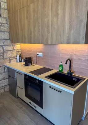 a kitchen with a sink and a stove at Gialos Villas Paleochora in Palaiochóra