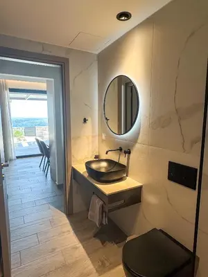 a bathroom with a sink and a mirror on the wall at Gialos Villas Paleochora in Palaiochóra