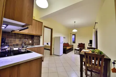 a kitchen and a living room with a couch at Niriides Apartments in Kissamos