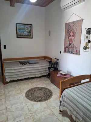 a room with two beds and a rug in it at Casa Ioanna - Elegant Residence in Kalivianí