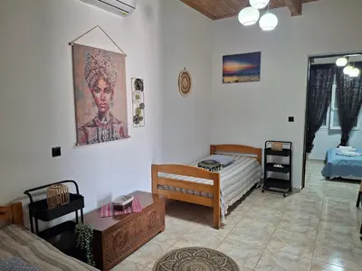 a living room with a bed and a table at Casa Ioanna - Elegant Residence in Kalivianí