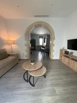 a living room with two tables and a couch at Casa di Keti in Chania Town