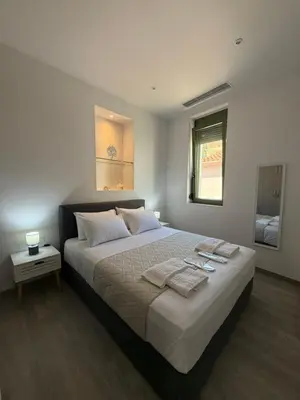 a bedroom with a large bed with towels on it at Casa di Keti in Chania Town
