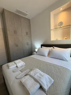 a bedroom with a large bed with towels on it at Casa di Keti in Chania Town