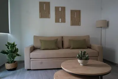 a living room with a couch and a table at Casa di Keti in Chania Town